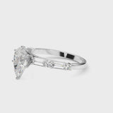 White gold Pear Cut Diamond Solitaire with Side Baguettes and Channel Set Band