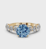 Yellow gold Fancy Blue Round Cut Diamond Prong Setting with Side Stones on a Pave Band