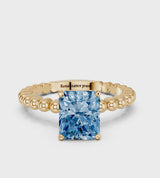 Yellow gold Fancy Blue Radiant Cut Diamond Solitaire Ring with Beaded Band and Prong Setting