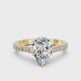 Yellow gold Pear Cut Solitaire Diamond Engagement Ring with Pave Band and Four-Prong Setting
