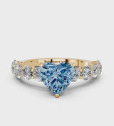 Yellow gold Fancy Blue Heart Cut Diamond Prong Setting with Side Stones on a Pave Band