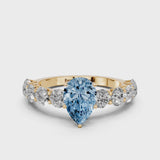 Yellow gold Fancy Blue Pear Cut Diamond Prong Setting with Side Stones on a Pave Band