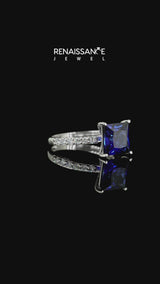 Silver Princess Cut Blue Sapphire Solitaire Ring with Round  Pavé Band and Prong Setting