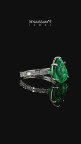 Silver Pear Cut Emerald Side Stone Solitaire Ring with Round and Four-Prong Setting