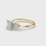 Yellow gold Three-Stone Emerald Cut Diamond Ring with Pear Side Stones and Four-Prong Setting