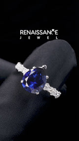 Silver Pear Cut Blue Sapphire Side Stone Solitaire Ring with Round and Four-Prong Setting