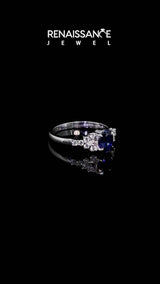 Silver Oval Cut Blue Sapphire Ring with Side Stones and Four-Prong Setting