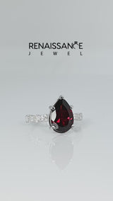 Silver Pear Cut Garnet Side Stone Solitaire Ring with Round and Four-Prong Setting