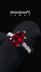 Silver Pear Cut Ruby Side Stone Solitaire Ring with Round and Four-Prong Setting