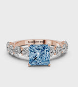 Rose gold Fancy Blue Princess Cut Diamond Prong Setting with Side Stones on a Pave Band
