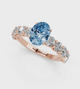 Rose gold Fancy Blue Oval Cut Diamond Prong Setting with Side Stones on a Pave Band